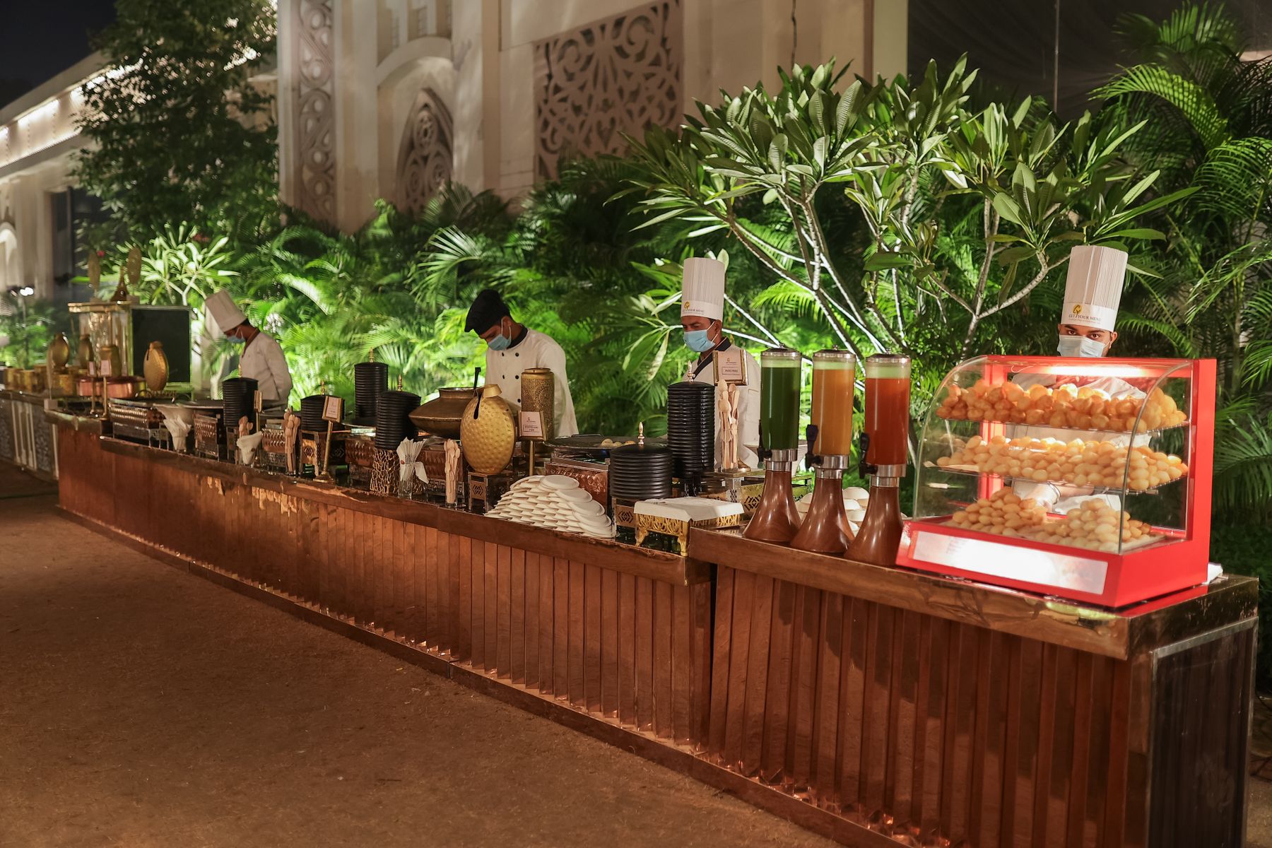 Chefs staffing an elegant outdoor buffet line at a night event